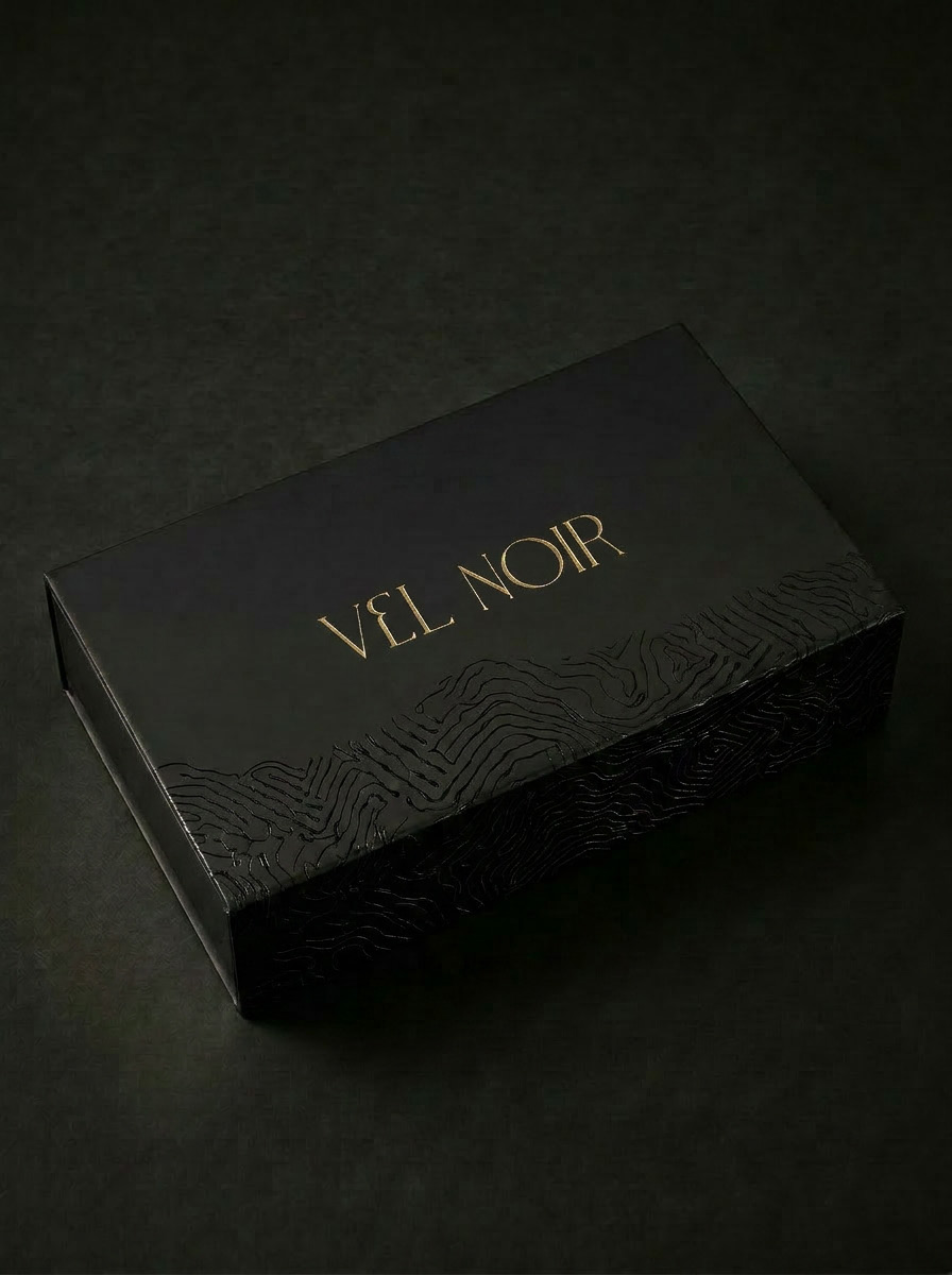 Vel Noir signature box with volumetric debossed pattern under dramatic editorial lighting